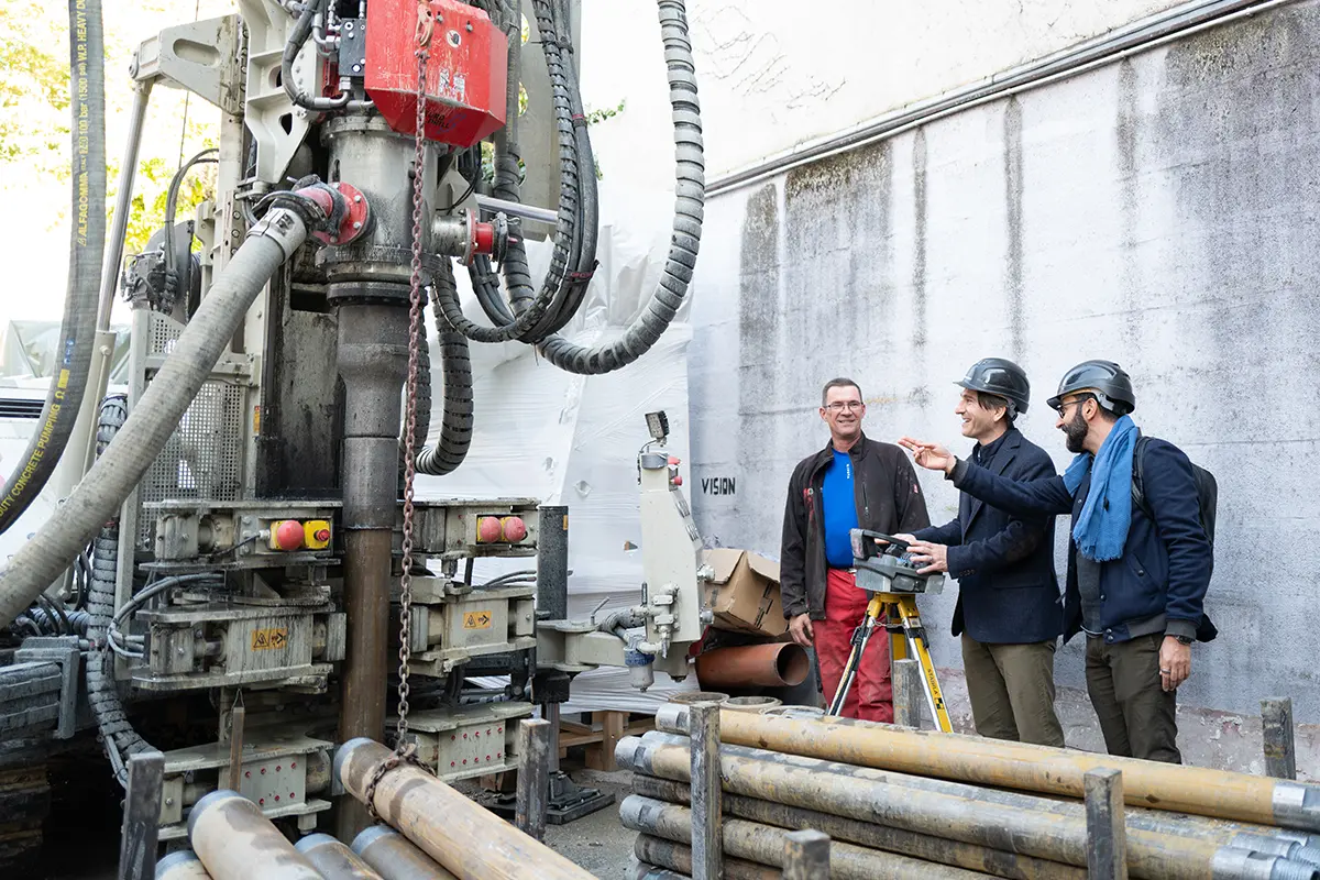 Drilling rig in the courtyard, taking measurements with a surveying instrument